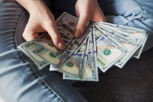 woman holding dollars